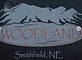 Woodland Trucking logo